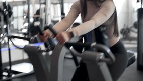 Latin American woman doing back muscle exercise on a machine at the gym, mourning routine and healthy lifestyle concept - Powered by Shutterstock - Get 15% off with code: PIKWIZARD15
