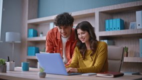 Successful coworkers collaborating on project using laptop and tablet closeup. Happy business colleagues discussing achievement giving five in modern workspace. Smiling team members working together. - Powered by Shutterstock - Get 15% off with code: PIKWIZARD15