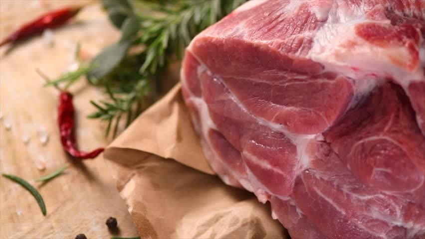 Raw pork meat, piece of meat, pork close up, ready to cook. Prime fillet meat texture. Chilled pork Boston butt, collar, shoulder. Steak. Raw pork neck, Spices. Slow motion. 