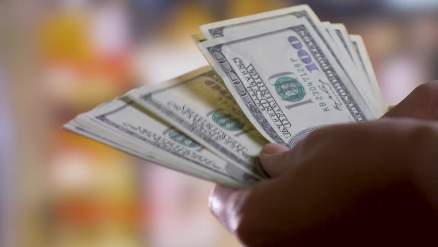 Hands hold and count cash money in hands. Passive income concept