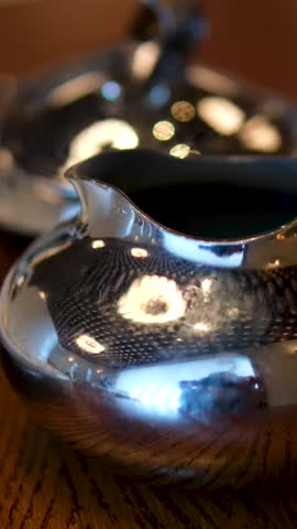 sugar bowl cup and milk jug Tea and Milk being Poured into the Ornate Tea Cup by a Setting of Tea and Biscuits and Sugar Bowl