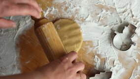 Grandmother teaching her grandson how to roll gingerbread dough in the kitchen. Concept of family bonding, baking together, and holiday traditions. High quality 4k footage - Powered by Shutterstock - Get 15% off with code: PIKWIZARD15