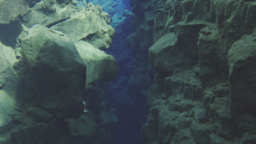 Between tectonic plates in underwater canyon depths revealing stunning rock formations in a vivid freshwater environment Silfra fissure iceland