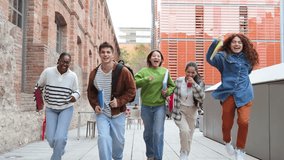 Group of students running happily after class, holding notebooks and backpacks, enjoying friendship, laughter, and energy outdoors on a bright day near modern educational buildings and campus pathways - Powered by Shutterstock - Get 15% off with code: PIKWIZARD15