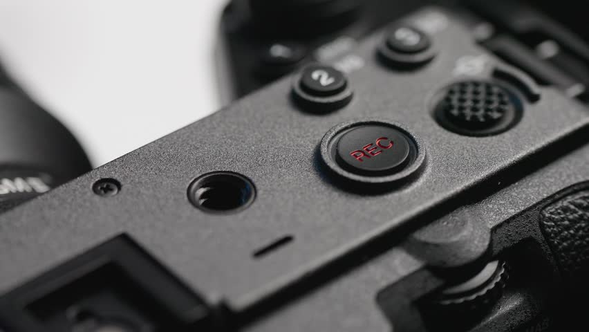 Macro shot of the Sony FX3's record button being pressed, illustrating the action of starting video recording