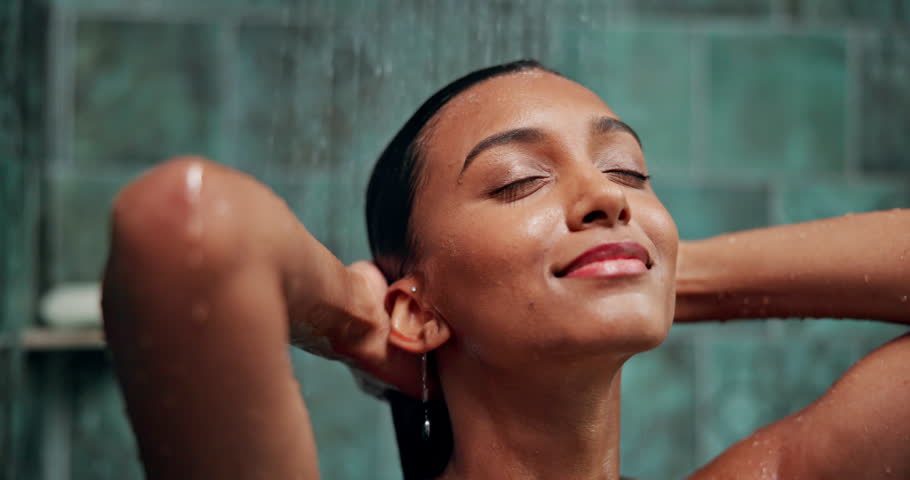 Shampoo, water and hair care with woman in shower for hygiene, beauty or repair treatment. Volume, cleaning and hairstyle with person and washing at home bathroom for skincare, hydration and cosmetic