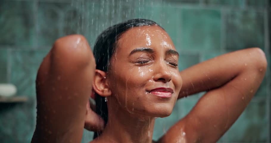 Shampoo, water and hair care with woman in shower for hygiene, beauty or repair treatment. Volume, cleaning and hairstyle with person and washing at home bathroom for skincare, hydration and cosmetic