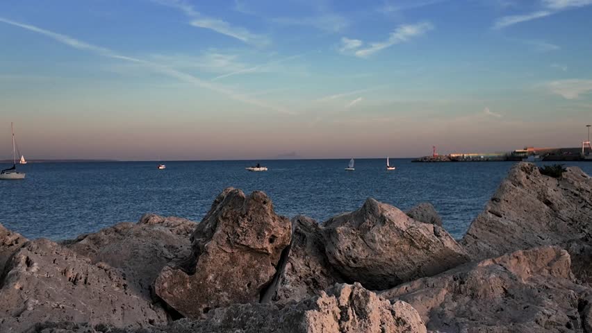 A serene view of a boat floating on calm waters in Anzio, Italy, captured in 4K resolution Perfect for travel, tourism, and maritime themes, showcasing tranquil seascapes a peaceful coastal enviroment