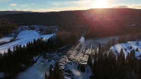 Ristafallet Waterfall in Winter Surrounded by Forests and Sunlit Swedish Hills - Powered by Shutterstock - Get 15% off with code: PIKWIZARD15