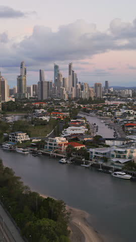 Aerial vertcial clip over the Gold Coast highway approaching downtown Surfers Paradise at sunset