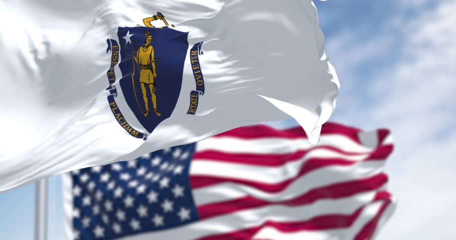The flags of Massachusetts and the United States waving in the wind on a clear day. Patriotism and identity concept. Seamless 3d render animation. Slow motion loop. Selective focus