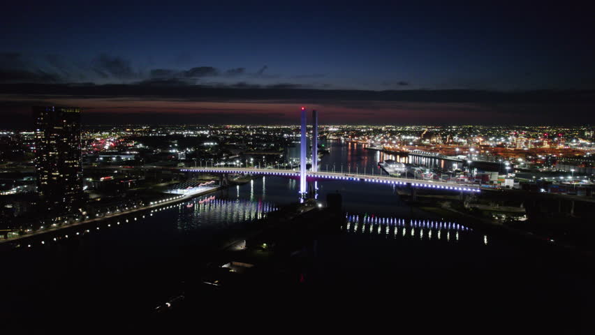Establishing aerial toward Bolte Bridge illuminated at dusk, Melbourne