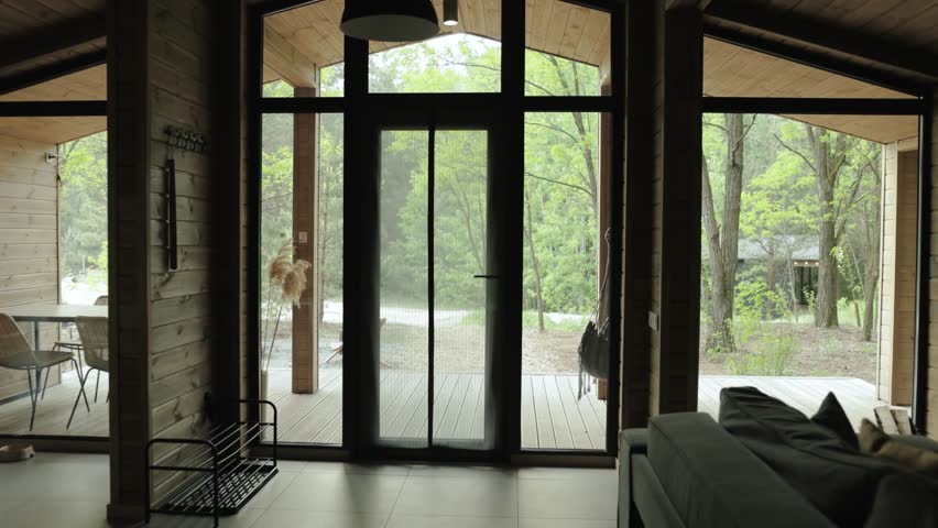 A Modern Interior Featuring Large Windows Offering Beautiful Views Overlooking Nature