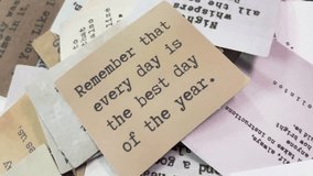 Overhead shot of a vintage-style card quote, "Remember that every day is the best day of the year" among other typewritten messages on aged paper, creating nostalgic and thoughtful atmosphere. - Powered by Shutterstock - Get 15% off with code: PIKWIZARD15