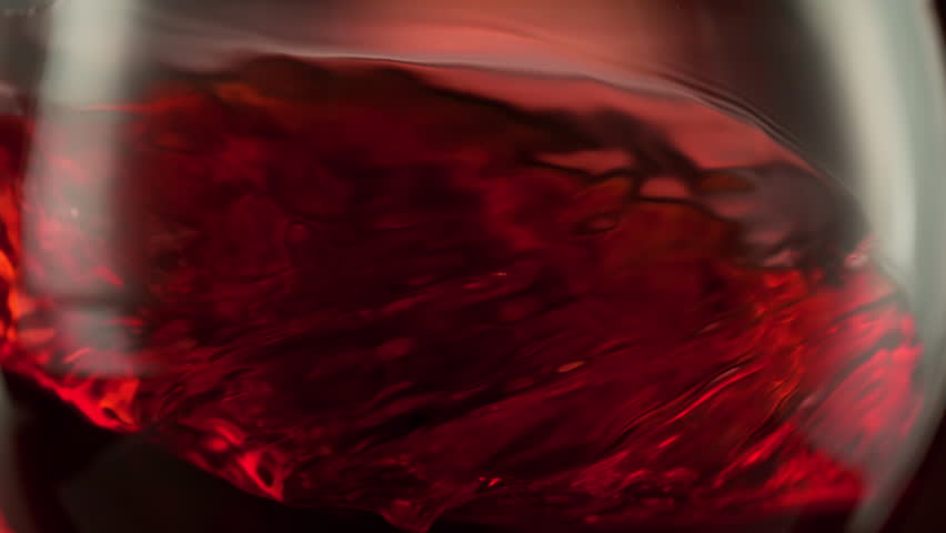 Super Slow Motion Macro Shot of Spinning Red Wine in Glass at 1000fps.