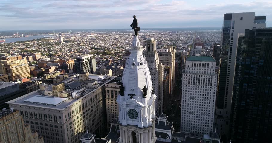 Statue of William Penn on Philadelphia City Hall Tower. Beautiful Cityscape. Business District and Downtown. Morning Sunlight. 4k