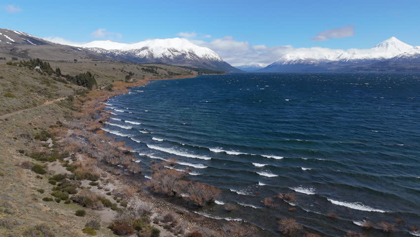 Wide panorama of Lake Huechulafquen with view of snow-capped Lanín Volcano in national park. Patagonia, Argentina.