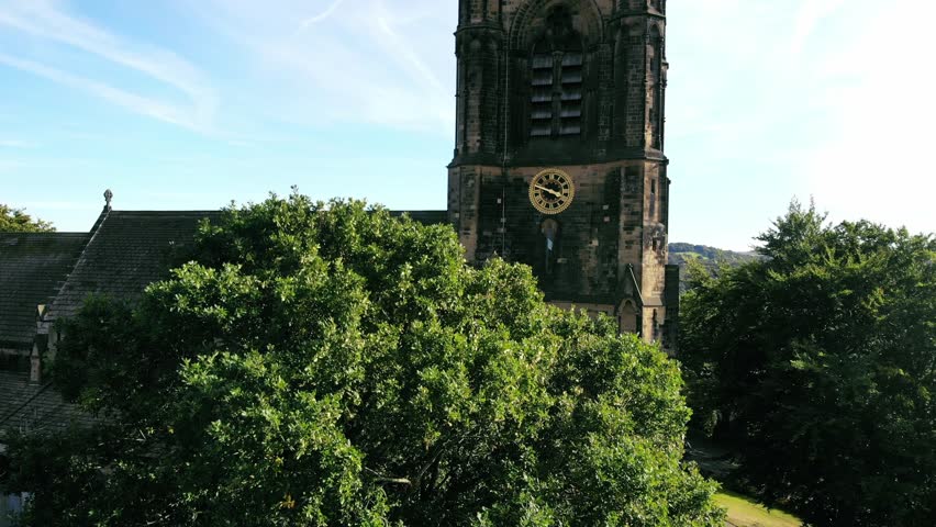 Old English Church clock and tower aerial drone 4k shot selective focus