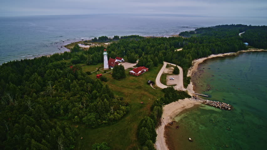 Drone shot twisting around Lake Michigan lighthouse
