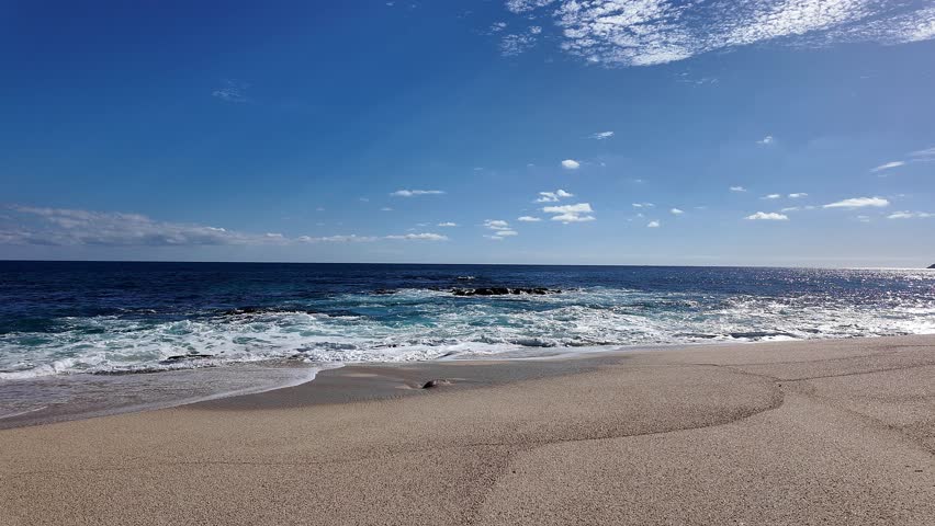 Waves crashing on the beach shore of Cabo San Lucas Mexico near San José del Cabo.