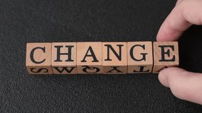 The inscription chance or change with wooden cubes on a dark concrete background. Can be used as part of your composition - Powered by Shutterstock - Get 15% off with code: PIKWIZARD15