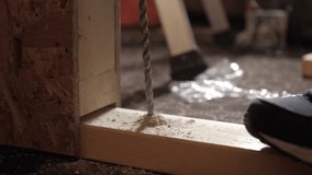 A close-up shot of a drill bit piercing through wood, showcasing the precision and detail involved in woodworking. - Powered by Shutterstock - Get 15% off with code: PIKWIZARD15