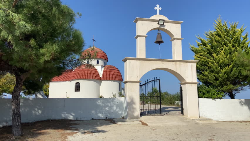 Cathedral on the rock. Orthodox church on top of a mountain, on the shores of the Aegean Sea in Greece. The church is white on a sunny day. High quality 4k footage