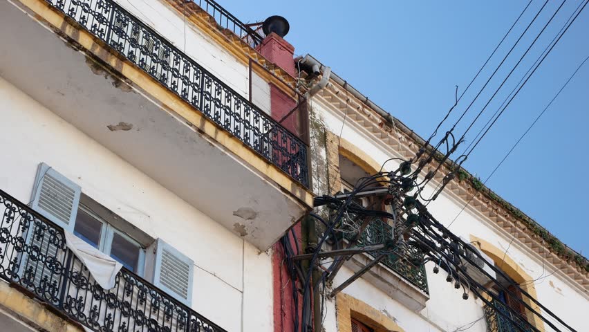 Swarm of cables on the facades of old french colonial houses in Constantine, Algeria