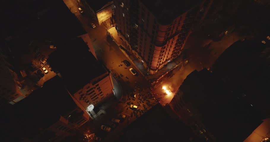 Protesters riot burning small isolated fire in intersection on street at night to protest Government decision in Georgia, Tbilisi. Manifestation agains Russian direction of Georgian Government. 