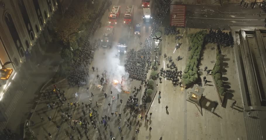 Water cannon truck disperses demonstrators during a manifestation in Tbilisi, Georgia. Protesters stand for EU. European Union manifestation. Georgians stand for EU. protests agains Government. 