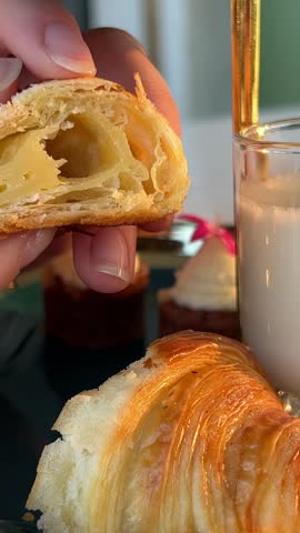 mini croissant with milk in the hands of girl. croissant structure