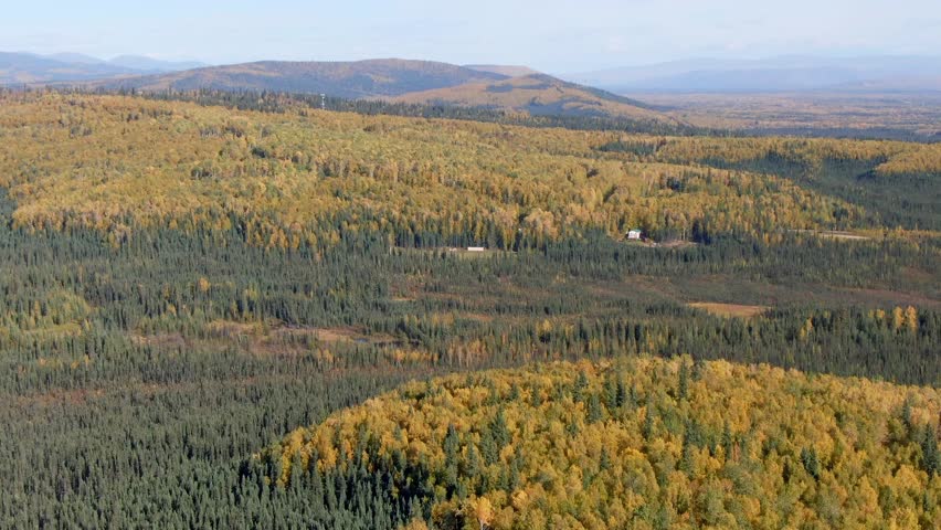 Sunny and cloudy skies over Alaskan fall landscapes, featuring colorful foliage