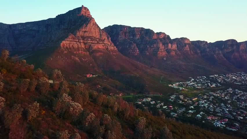 Sunset Aerial Shot over Lion's Head slopes towards Table Mountain and Camps Bay