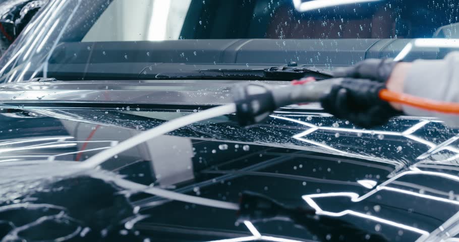 Gentle Car Wash for a Shiny Finish. A gentle yet effective car wash technique is used to maintain the shine of a luxury vehicle. The attention to detail is evident in every step of the process.