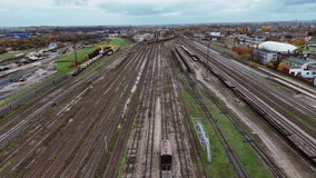 Empty train tracks and stationary freight cars in an open rail yard, aerial view - Powered by Shutterstock - Get 15% off with code: PIKWIZARD15