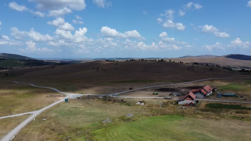The cloudy landscape of a farm in the mountains