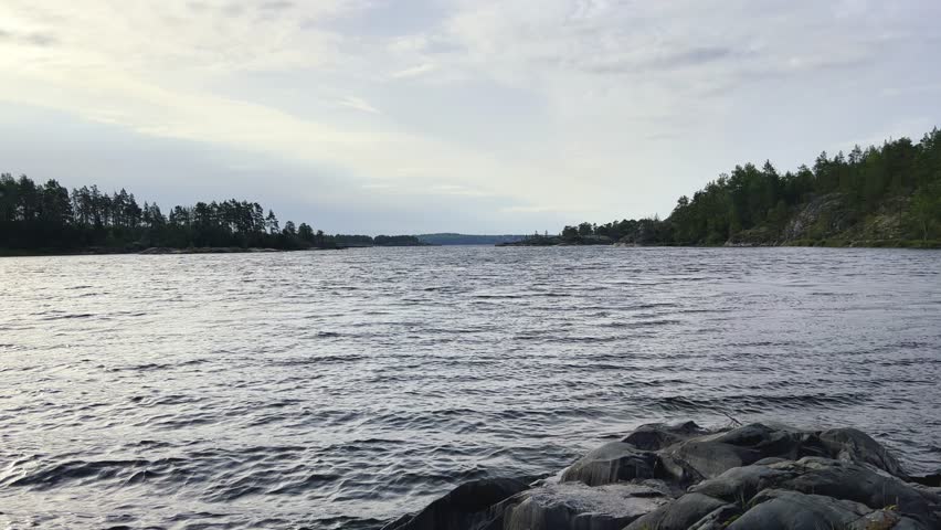Russia, Karelia, Lake Ladoga, Impilampi. View of the coast of the island in a cold lake. The beautiful nature of the Republic of Karelia. Stunning panoramic view of the Ladoga skerry Islands. 4K