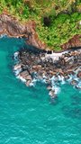 Lovely turquoise water of the Indian Ocean at the coast of Sri Lanka. House hides among the palm trees on the beautiful shore. Vertical video. - Powered by Shutterstock - Get 15% off with code: PIKWIZARD15
