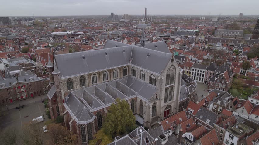 A drone footage of the 12th-century former church of Saint Peter (Pieterskerk) on a cloudy day in Kloksteeg, Leiden, Netherlands
