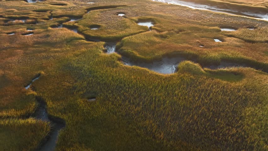 Flying Over Salt Marsh At Sunrise In Cape Cod, Barnstable, Massachusetts - Drone Shot