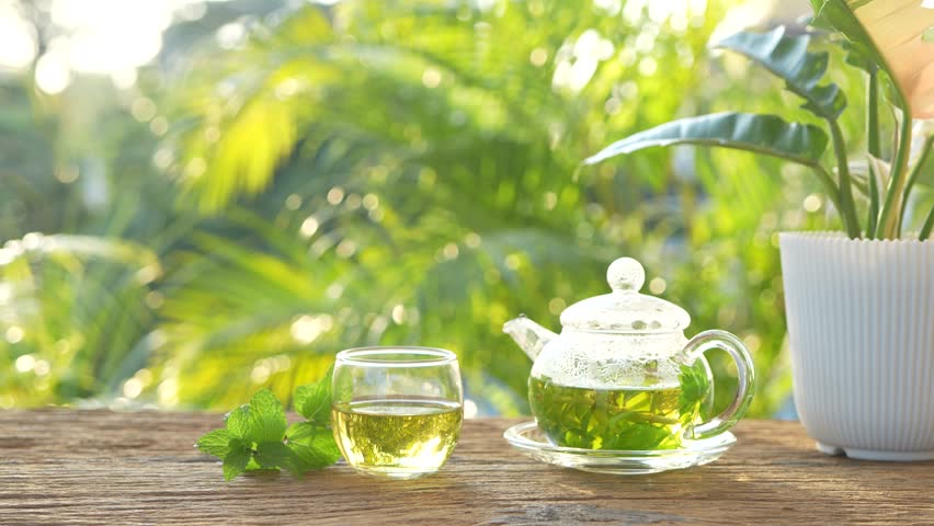 herbs tea, coriander, Lemon balm, Rice Paddy Herb in a glass teapot 