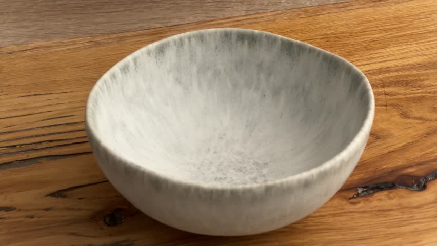 cook housekeeper pour honey in a bowl on wooden board in kitchen. process of making homemade meal, cooking at home, food closeup, cooking pork roast with glaze