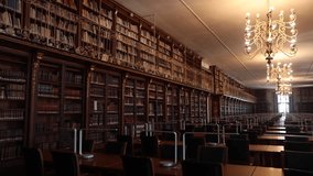 Large, historic library in Santiago de Compostela with chandeliers and wooden bookshelves - Powered by Shutterstock - Get 15% off with code: PIKWIZARD15
