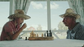 grandfather and grandson play chess in the garden outdoors - Powered by Shutterstock - Get 15% off with code: PIKWIZARD15