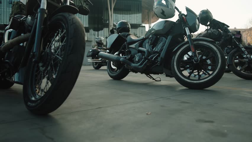 Classic customised motorcycle parked outside in a cloudly weather .