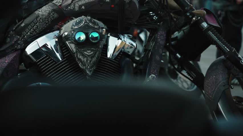 Classic customised motorcycle details parked outside in a cloudly weather .