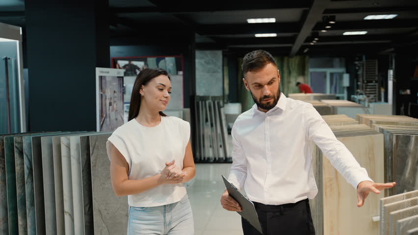 Sales Consultant Assisting Customer in Tile Showroom