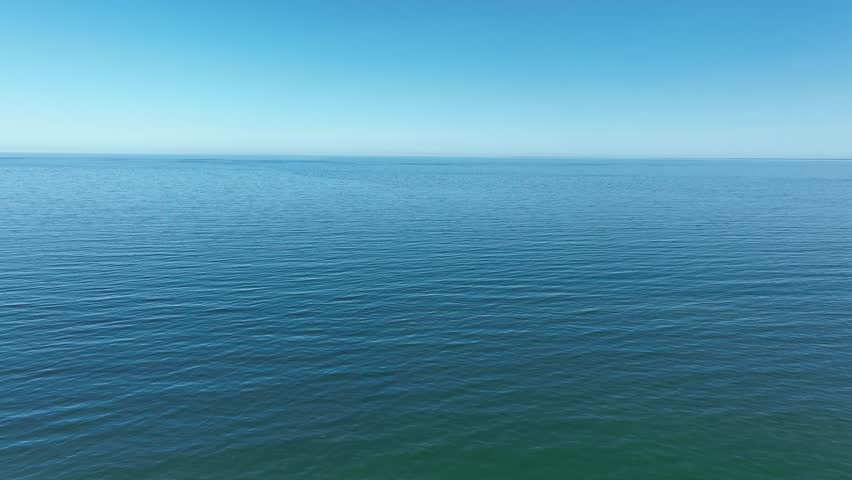 Calm Atlantic Ocean view from Cape Cod under a clear blue sky with gentle waves