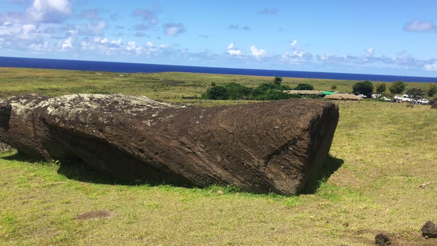 Moai under construction in a beautiful sunny landscape over Ranu a Raraku in a summer day in Easter Island, Rapa Nui, Polynesia, Chile, Latin America.