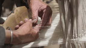 A skilled craftsman weaves a traditional wool fabric on old antique wooden loom in Ladakh, India - Powered by Shutterstock - Get 15% off with code: PIKWIZARD15